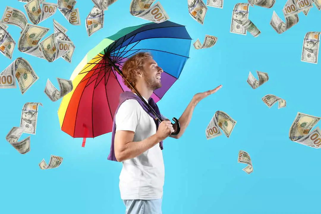 Man with rainbow umbrella on color background